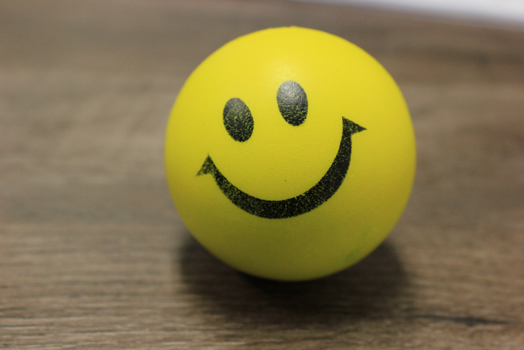 Smiley Ball on a Wooden Surface